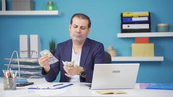 Businessman counting money looking at camera. video