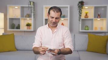 Man counting money looking at camera. video