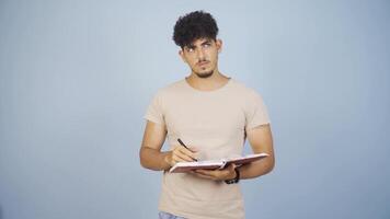 Man with notebook thinks and takes notes. video