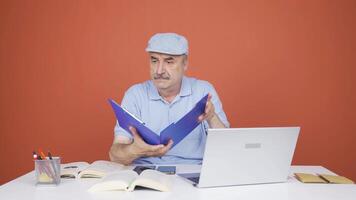 Man working on laptop throws files angrily. video