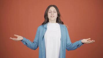 Young woman meditating looking at camera. video