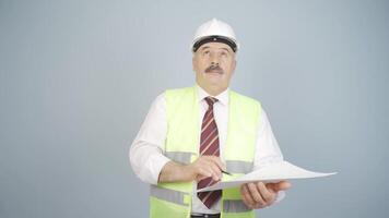 Looking up, the engineer is holding his hard hat. video