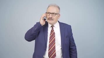 Angry talking businessman on the phone. video