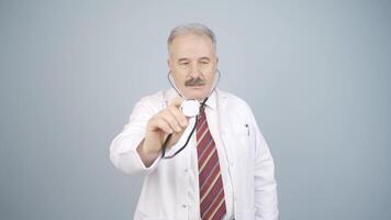 Doctor listening to camera with stethoscope. video