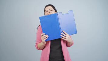 Business woman looking from behind files. video