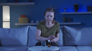 Depressed woman is taking antidepressant pills. video