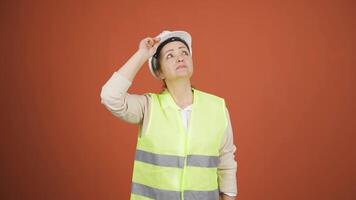 Looking up, the engineer is holding her hard hat. video