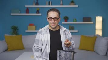 Man with no vision problems throws glasses in trash. video