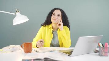 Young woman looking at laptop is thoughtful. video