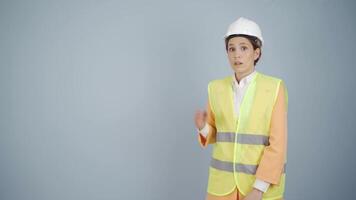 Engineer looking at camera in amazement and making a presentation. video