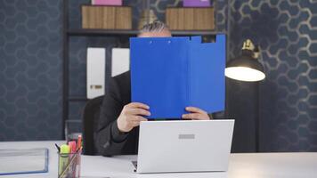 Cheerful businessman working on files. video