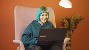 Satisfied with what she sees on the laptop, the young woman nods. video