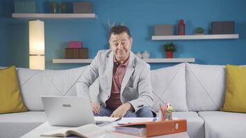 Home office worker man experiencing joy looking at camera. video