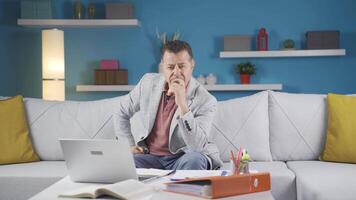 Home office worker man thinking looking at camera. video