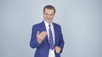 Businessman making a trust sign at the camera. video