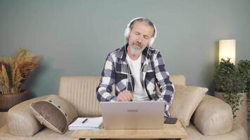Man looking at laptop is happy and dancing. video