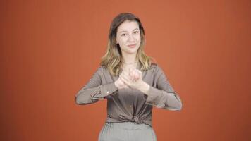 Young woman looking at camera making confidence sign. video