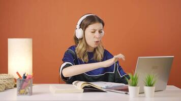 Satisfied with what she sees on the laptop, the young woman nods. video