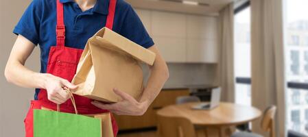 Young handsome man holding delivery paper bag photo