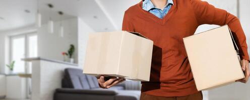 man moving to a new home with box photo