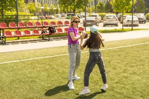 mother and daughter playing american football photo