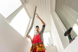 male industrial builder worker at window installation in building construction site photo