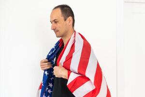 Caucasian businessman holding the flag of America isolated on white background. photo
