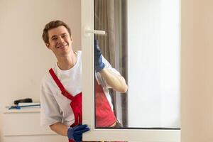 A repairman fixing windows in new apartment. photo