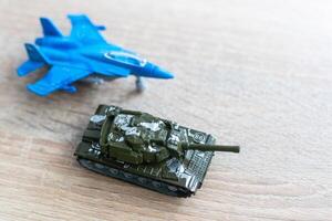 The image shows models of tanks and fighter jets on a white background, close up. photo