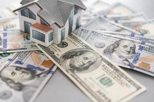 Small Model House on Newly Designed U.S. One Hundred Dollar Bills. photo