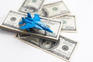 Toy plane and money on background. Travel insurance photo