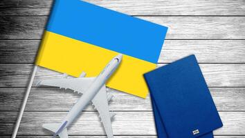 Ukrainian flag and toy plane on gray background photo