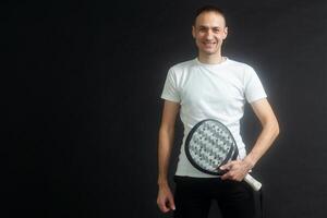 Man ready for paddle tennis serve in studio shot photo