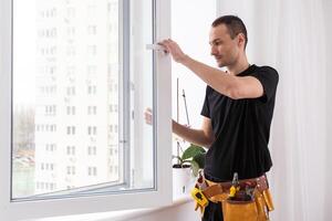 male industrial builder worker at window installation in building construction site photo