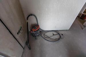 Professional vacuum cleaner on the lacquered parquet floor photo