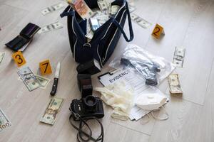 Black duffel bag full of dollar notes in criminal investigation unit, conceptual image photo