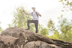 man hand holding hiking pole with green bokeh background and copy space. Summer activity for adventure person concept. photo