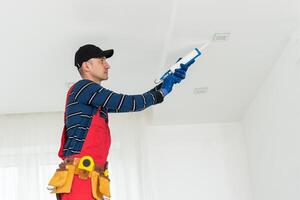 Construction worker ceiling work. working on repairs photo