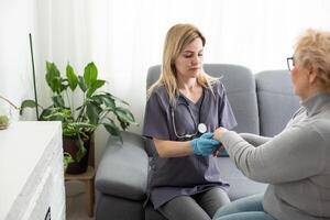 Happy patient is holding caregiver for a hand while spending time together. photo