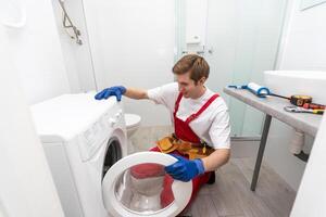Plumber Fixing Domestic Washing Machine photo