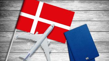 Traveling to Denmark, top view passenger plane on Denmark flag photo