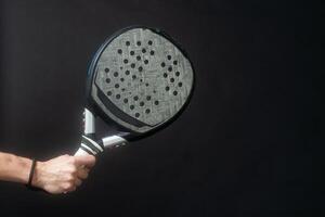 Man ready for paddle tennis serve in studio shot photo