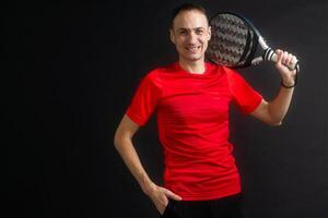 Man plays paddle tennis and poses in studio photos on white black background