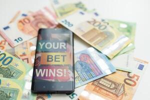 betting on sports, smart phone with working online betting mobile application photo