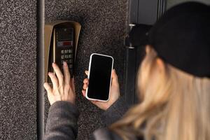 woman open the safety door with smart phone photo