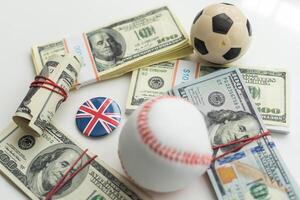 Small balls on heap of dollars isolated on a white background photo