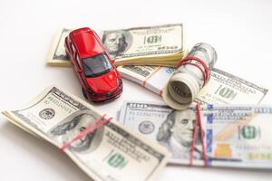 Small decorative car model, a lot of cash dollars of USA, credit for car concept photo