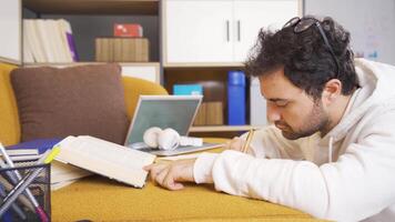 Man doing research, reading books, writing. video