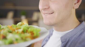 Man looking at salad with appetite. video