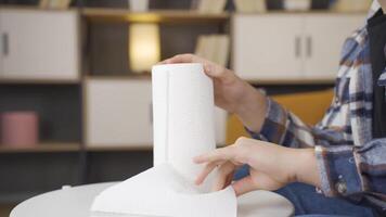 Man tearing off paper towel and using it video